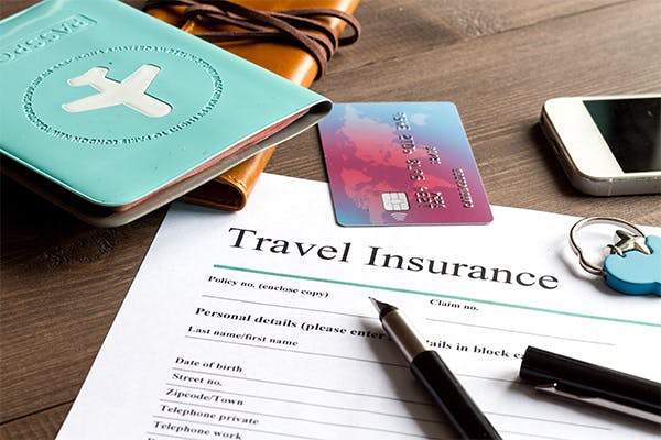 concept-booking-travel-insurance-on-wooden-background